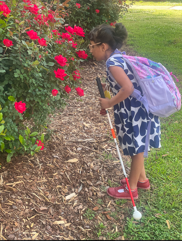 Ankitha smelling roses