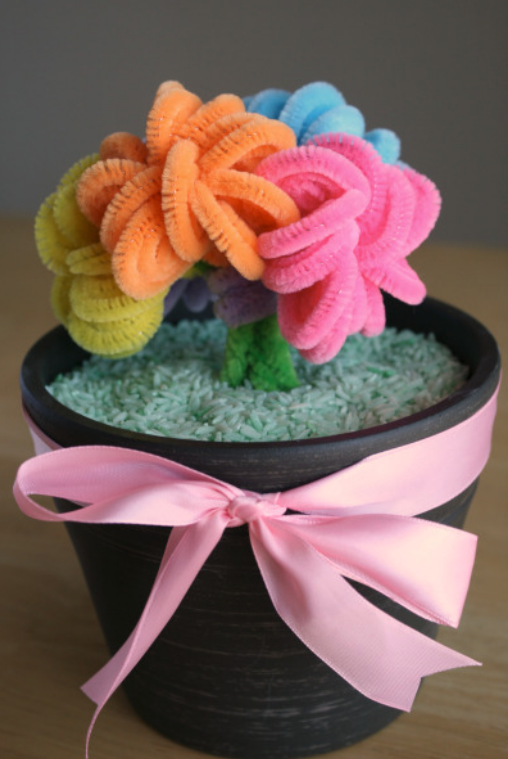 Flowers made out of pipe cleaners put in a small flower pot 