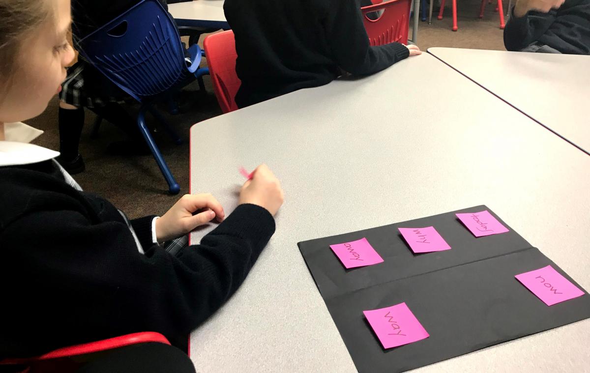 Student looking at high contrast words on a black background