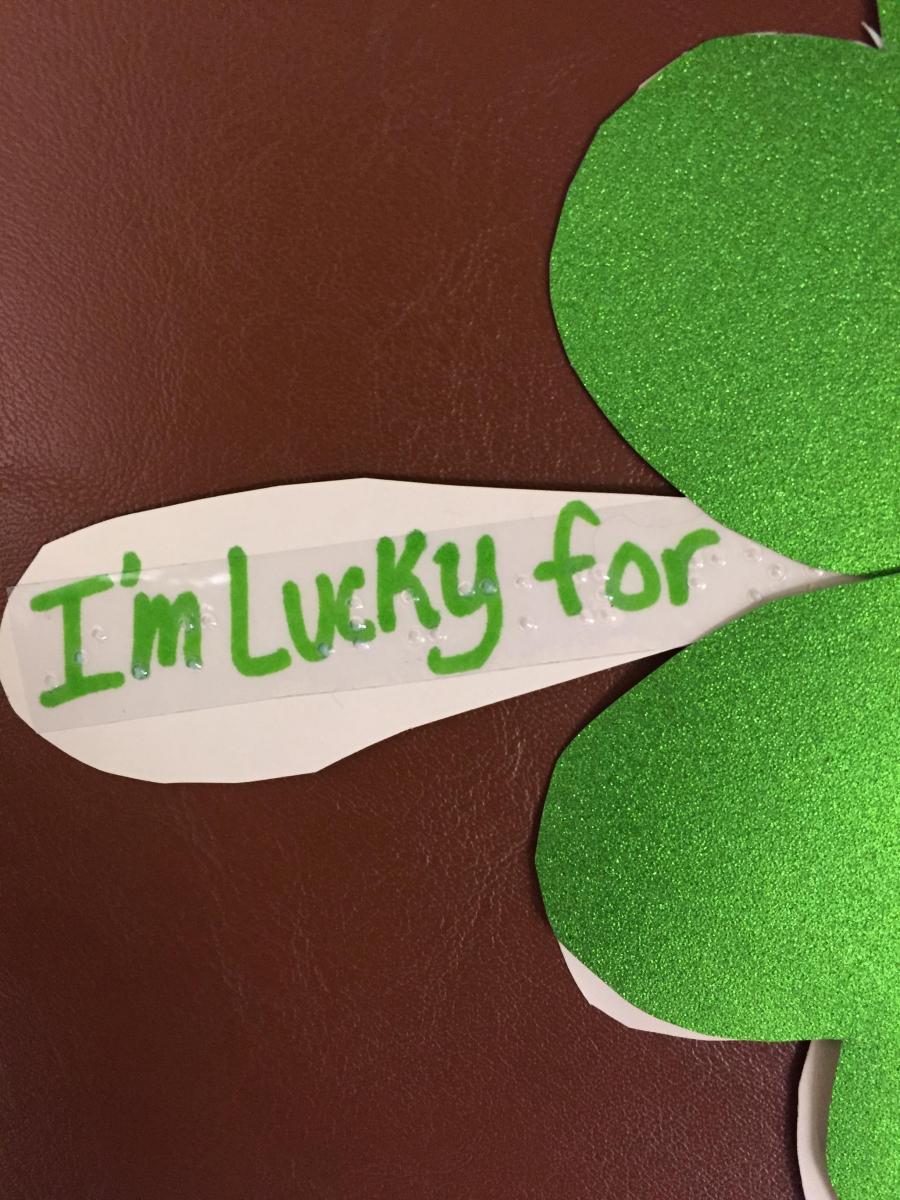 Shamrock with braille "I am lucky"