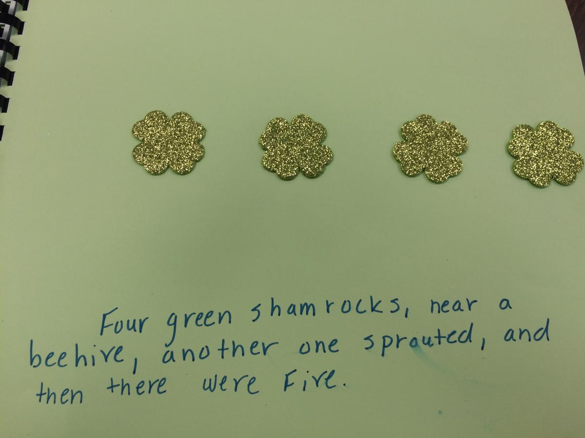 Four green shamrocks, near a beehive, another one sprouted, and then there were five.