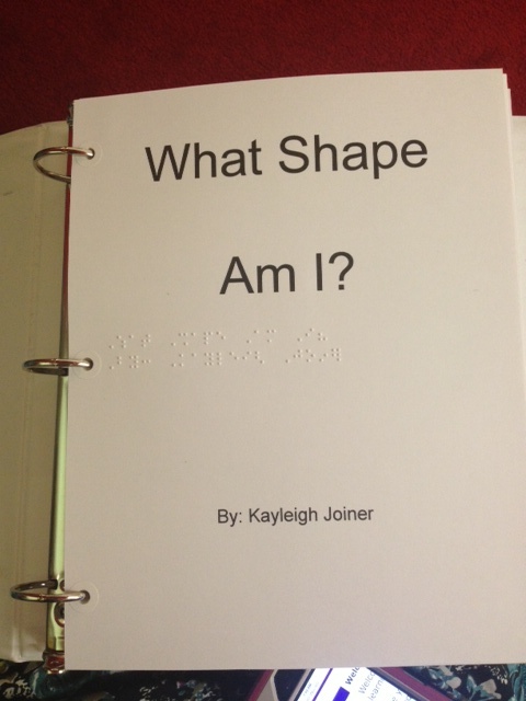 Title page with text "What Shape Am I?" and in braille