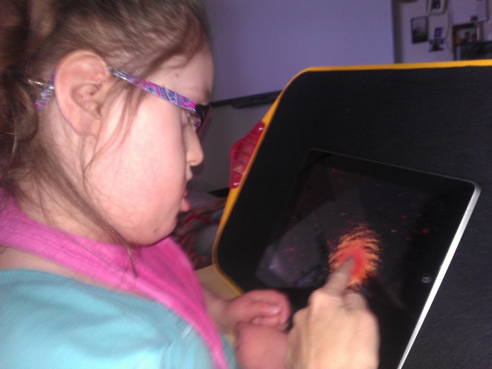 Student with a visual impairment and other disabilities using an iPad 
