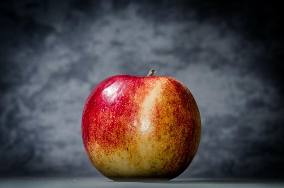 A red apple with a black background