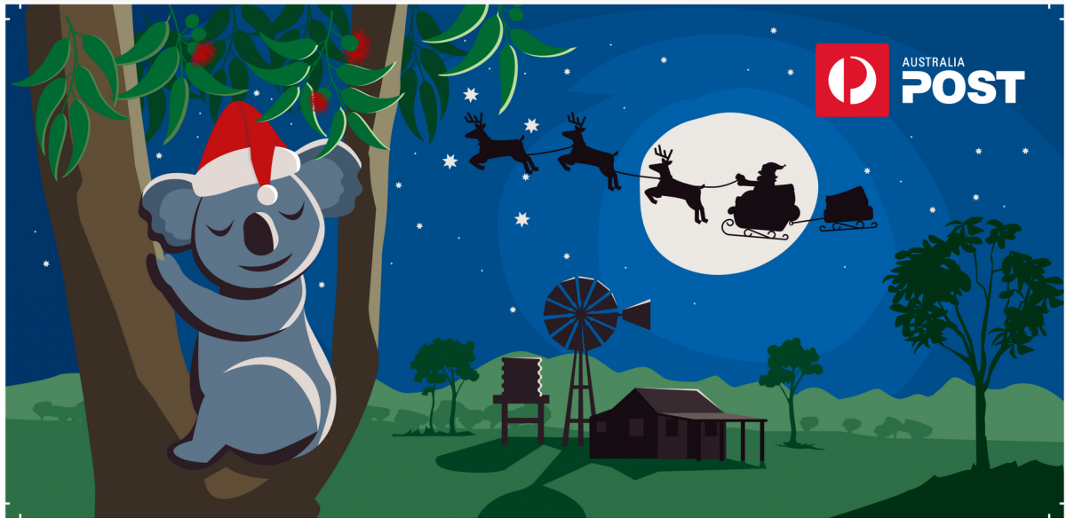 Koala bear with Santa hat asleep in tree