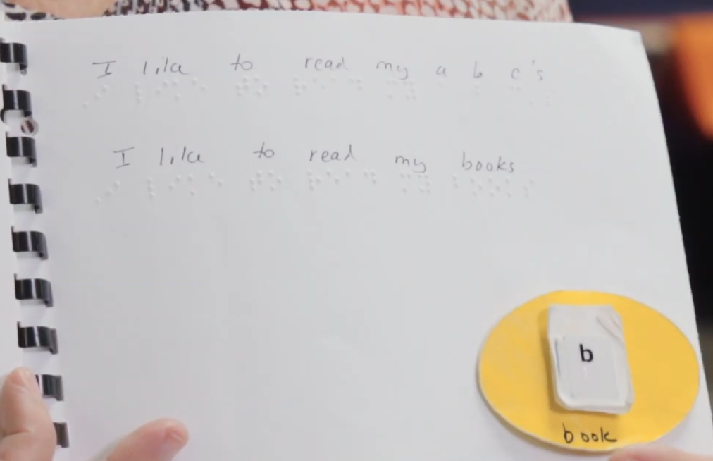 Braille book with tactile symbol for "book"