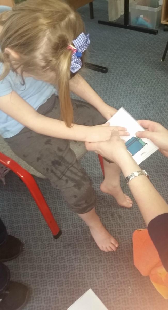 Girl using a communication card to find out what will happen next