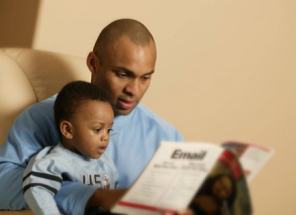 Father reads with young son