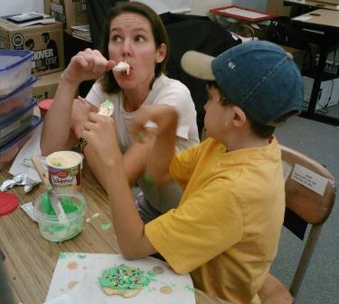 Teacher eating frosting while student looks on