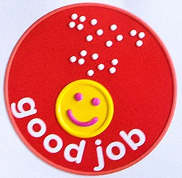 Tactile sticker saying "Good job" in print and braille