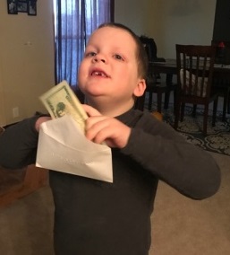 Liam putting his lunch money in the envelope