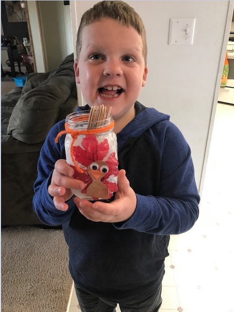 Liam standing and showing off his final turkey jar