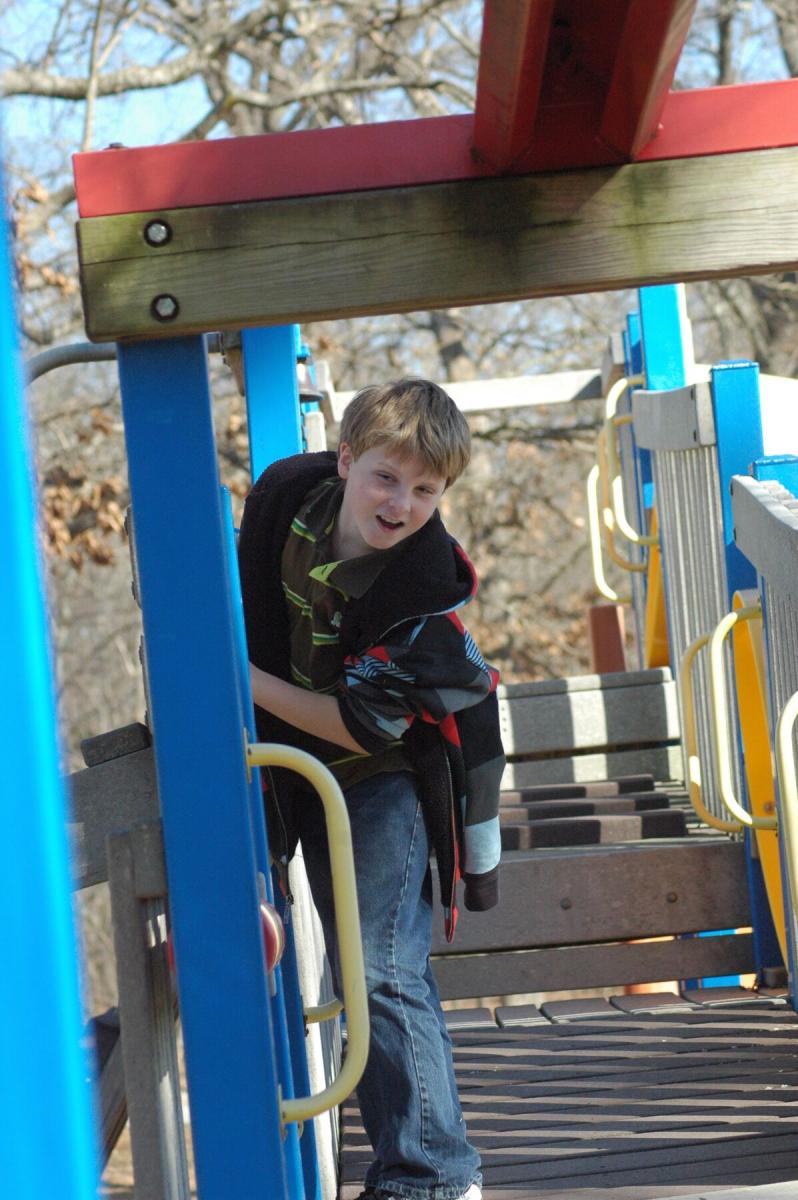A boy playing on playground equipment