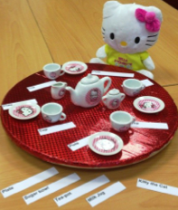 doll set at lazy susan with plates and tea cups