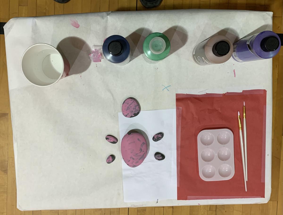 Palette with bottles of paint, paintbrushes, and finished "turtle"