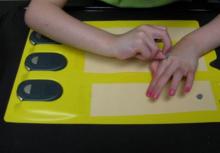 Girl putting dots on braille activity