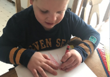 Liam drawing at the table