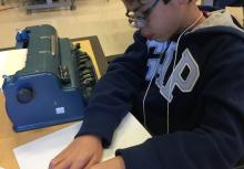 A student reads a braille passage during the Braille Challenge.