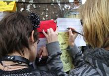 Two girls writing on paper