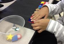 Child using shapes to create patterns.