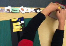 Student using tactile symbols with braille