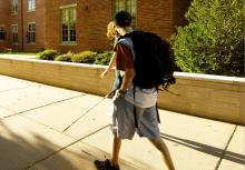 Student walking with cane