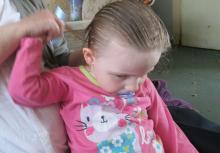 young girl combing her hair