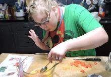 A girl stirs ingredients in a bowl.