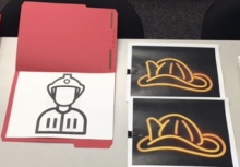 outline of fireman and two fireman hats with colored overlay