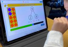 student using an iPad math app in her classroom