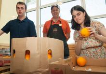 Two students examine oranges