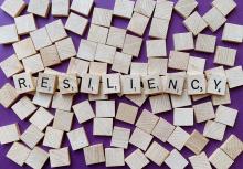 Scrabble tiles spelling out "RESILIENCY"