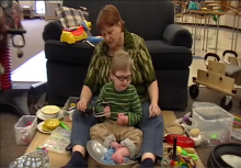 Adult seated with child on Resonance Board