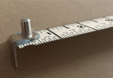 Ruler with L-shaped support peg