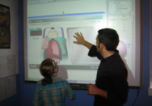 teacher showing student interactive whiteboard