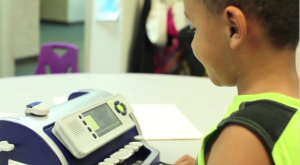 Boy using SMART brailler