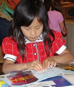Girl reading braille