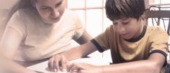 A boy reads braille