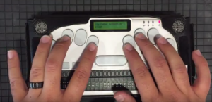 Fingers on keyboard of Braille Sense