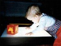Toddler explores the surface of a light box
