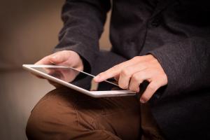 two hands are shown swiping on an ipad