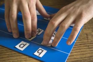 a student manipulates the magnetic tiles