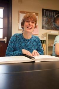 A girl reads a braille book.