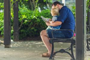 Father reading to young child
