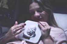 Mother feeling 3-D print of baby