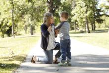 A mother signs with her son