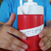 Hands holding a thermos with braille on it