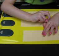 Girl putting dots on braille activity