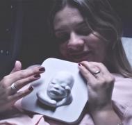 Mother feeling 3-D print of baby