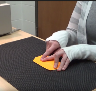 Student reading braille flashcard